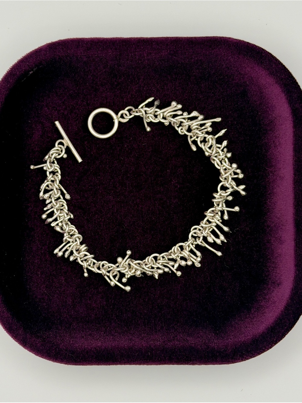 Nordstrom Silver Textured Twig Toggle Bracelet on Plum Tray